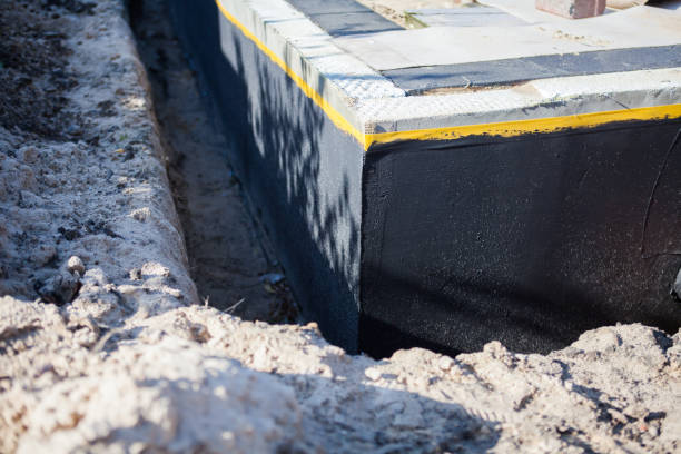 Professional Basement Waterproofing technician working in Rochester, NY